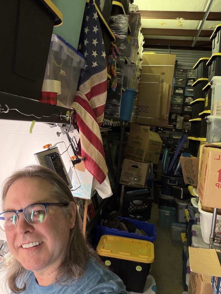 Whit at the GNUWHIT photography station inside a storage workspace