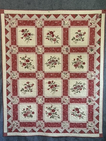 The French General Quilt by Michele Urbany Neely Puluti, featuring twelve red and cream floral panels framed by patterned sashing and a triangular border