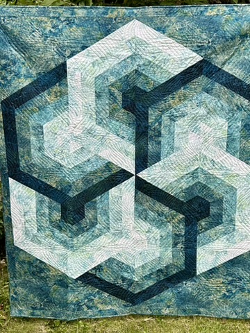 Triangle Frenzy quilt by Michele Urbany Neely Puluti, featuring interlocking teal, white, and navy geometric forms
